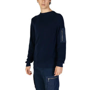 Navy blue long sleeved ribbed knit sweater with a zippered patch pocket on the left sleeve for casual wear