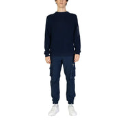 Navy blue long sleeved knit sweater featuring a subtle zippered pocket on the left sleeve for practical use