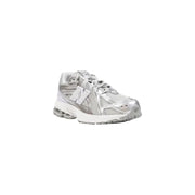Silver new balance sneaker with mesh upper and white sole.