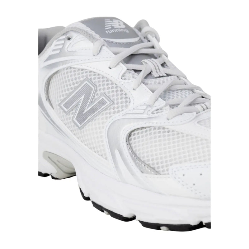 New Balance women grey faux leather sneakers with white running shoe design and silver mesh accents