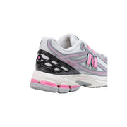 Back view of new balance women grey slip on textile skate sneakers in pink and gray with black mesh heel overlay