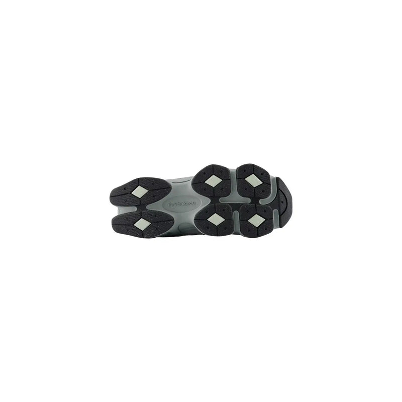 New balance women leather sneakers grey slip showing gray and black chunky sole with diamond-shaped rubber grips