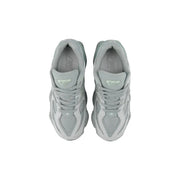 A pair of light gray New Balance women leather sneakers with chunky midsole and mesh upper slip-on design