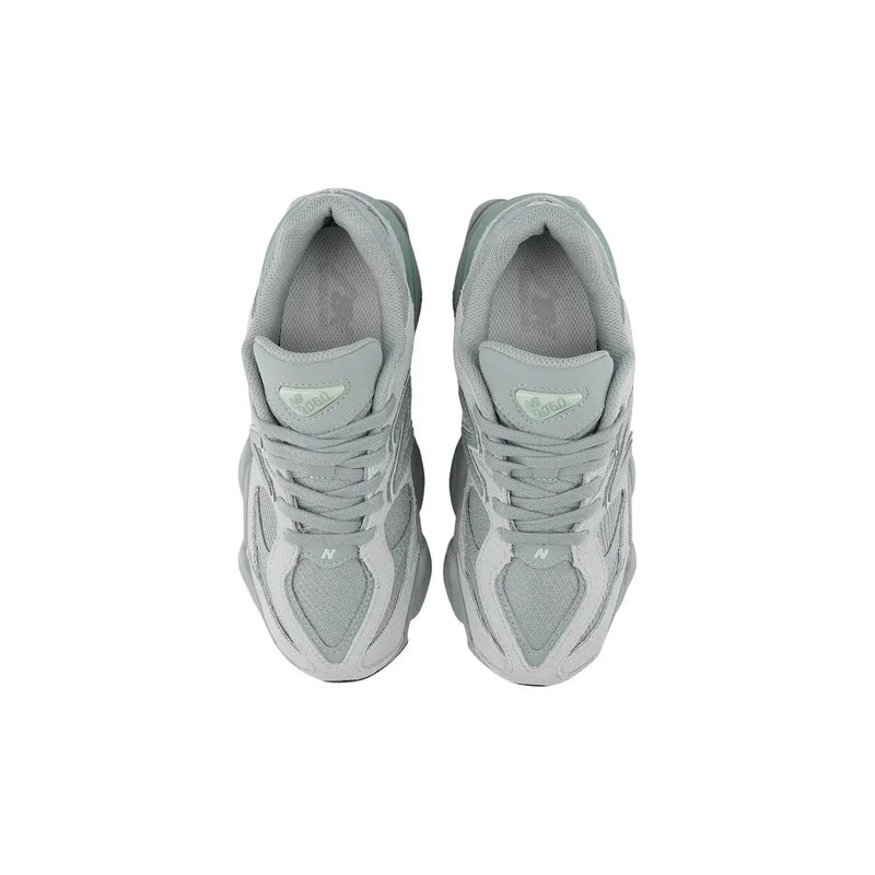 A pair of light gray New Balance women leather sneakers with chunky midsole and mesh upper slip-on design