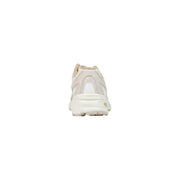 Cream-colored New Balance women running sneaker with white rubber sole and beige synthetic heel tab accents