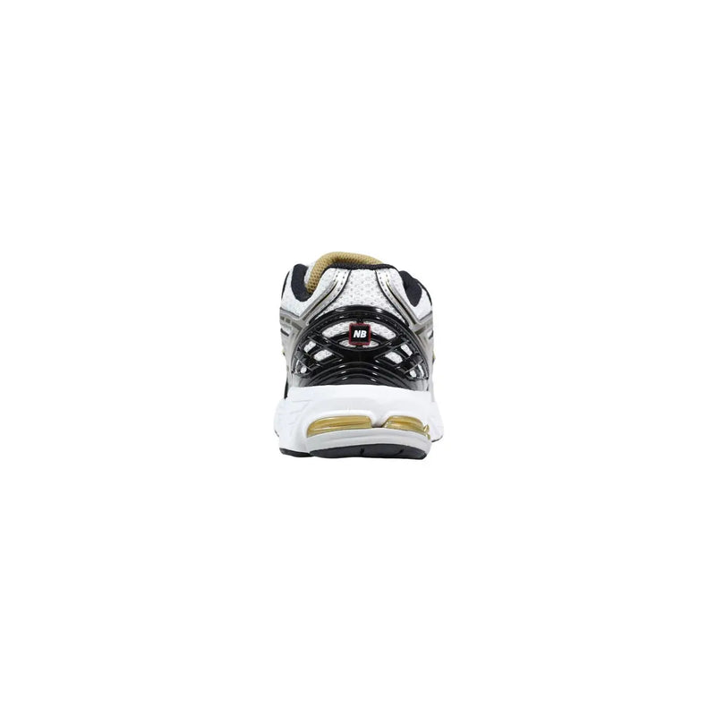New Balance women silver synthetic sneakers white and black running shoe with gold accents on heel and midsole back view