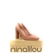 A pair of ninalilou women pink leather block heel pump shoes in nude color with pointed toe on branded box