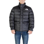 Black puffer jacket with hood and logo on chest, made of synthetic material.