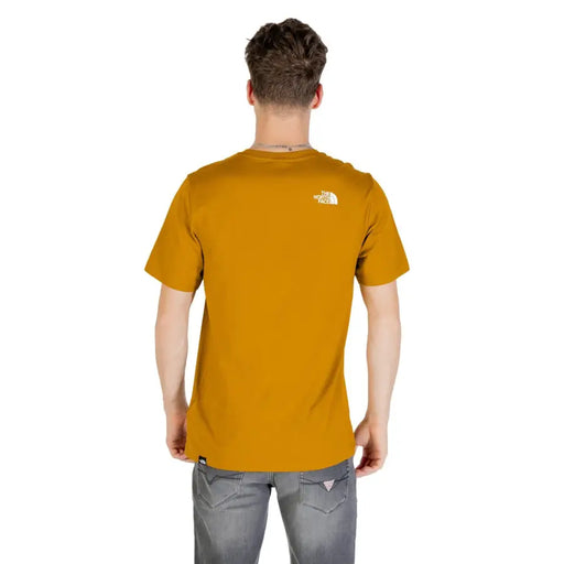 Men’s mustard yellow short-sleeve T-shirt with white logo on upper back, from The North Face