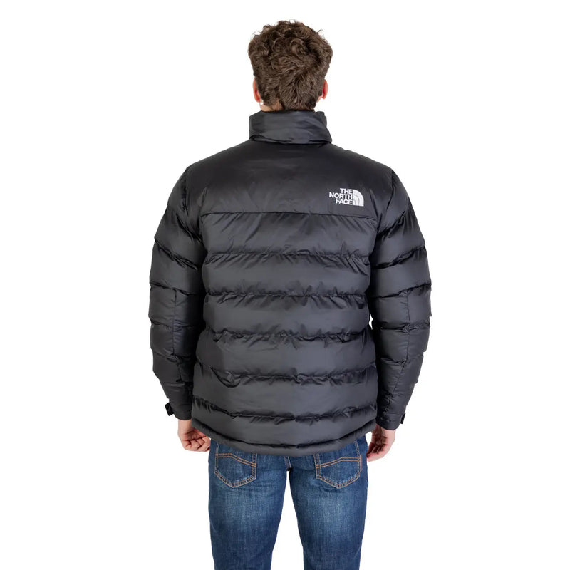 Die Rückseite einer schwarzen North Face Herrenjacke mit horizontalen Nähten, weißem Logo und langem Rollkragen aus Polyester.