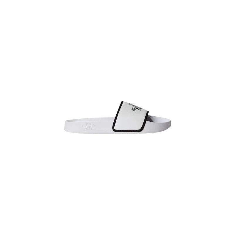 White slide sandal with black trim and minimalist logo on polyester strap from the north face men slippers white logo print