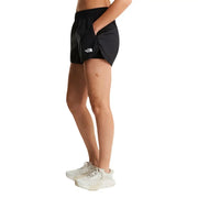 The North Face women black polyester shorts featuring a white logo on the left leg for outdoor activities