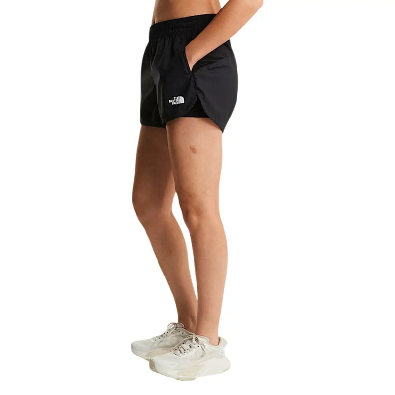 The North Face women black polyester shorts featuring a white logo on the left leg for outdoor activities