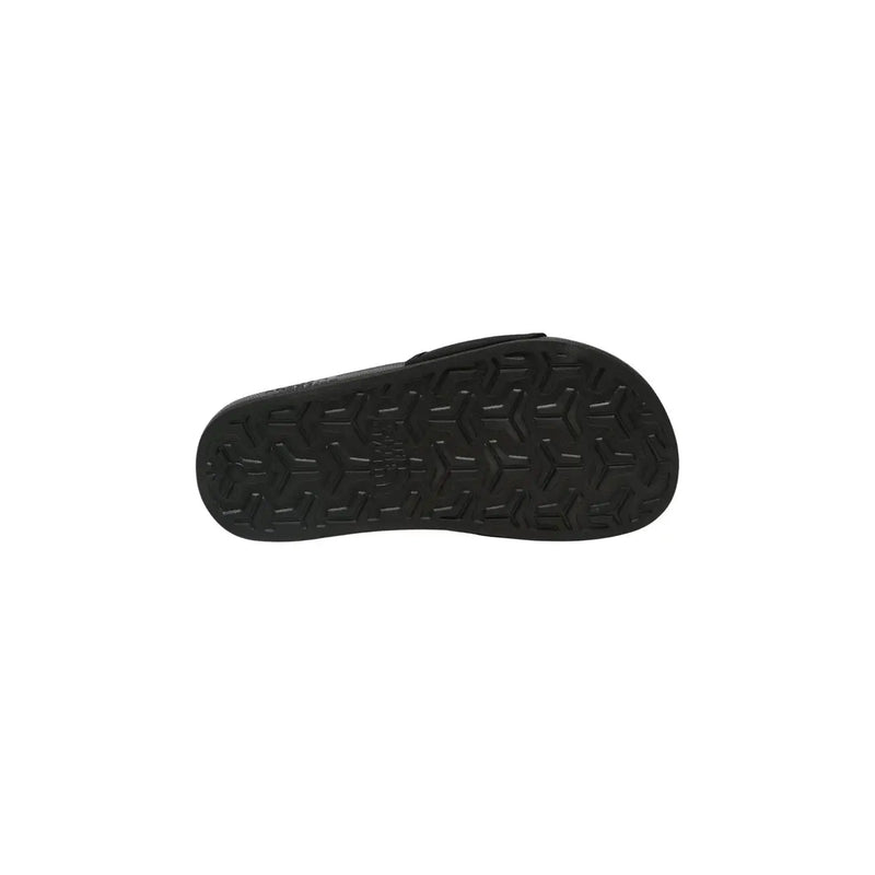 The north face women slip on slide slippers black showing the black rubber sole with geometric tread pattern
