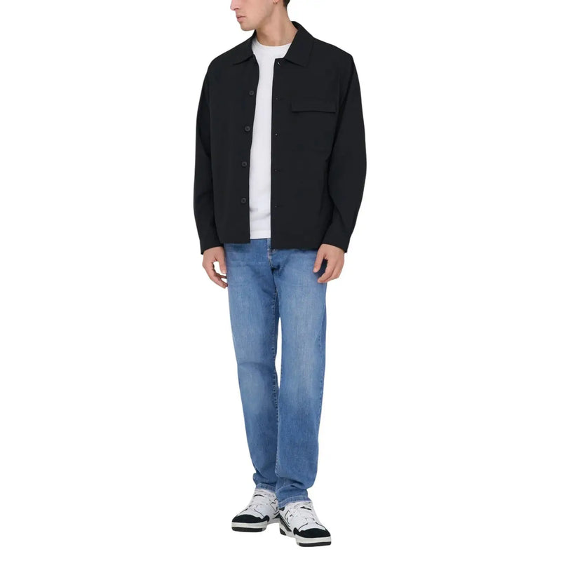 Black button up jacket with classic collar and chest pocket worn over white tee paired with only and sons men light blue cotton jeans