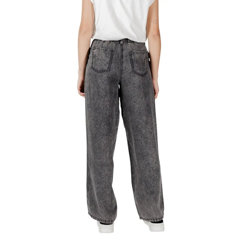 Wide-leg gray denim only women black lyocell jeans with faded distressed texture and classic back pockets shown from back side