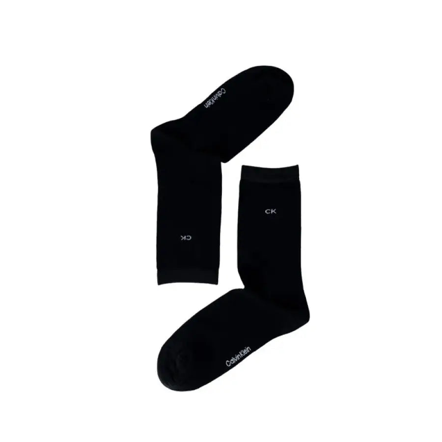 
                      
                        Calvin Klein black socks with white lettering, urban style clothing accessory
                      
                    