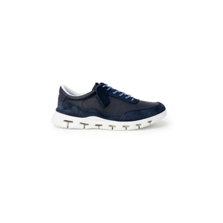 Navy blue Clarks men sneakers with white soles showcasing urban city fashion