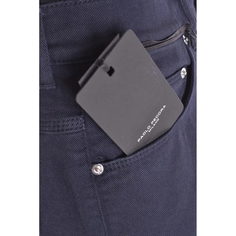 Black rectangular paolo pecora milano tag on the back pocket of dark blue cotton stretch denim trousers for men