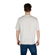 Ein Mann, der ein weißes, gemustertes Kurzarm-T-Shirt mit einem dezenten hellgrauen geometrischen Muster trägt.