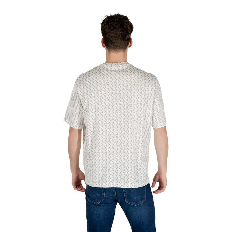 A man wearing a white patterned short sleeve t shirt with a subtle light gray geometric design