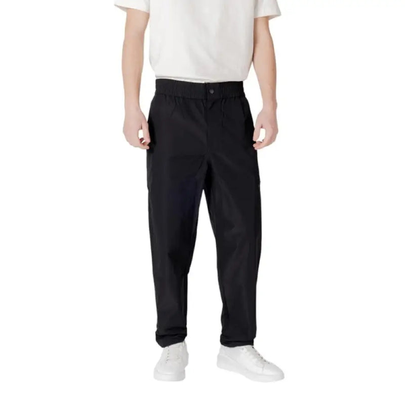 Person wearing Black Athletic Cargo Pants and white shoes demonstrating style and comfort