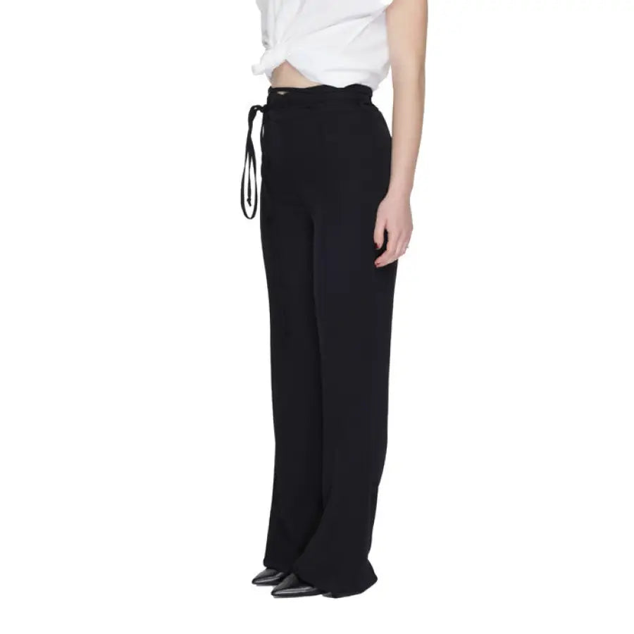 
                      
                        Sandro Ferrone women trousers in urban style clothing on person in black
                      
                    