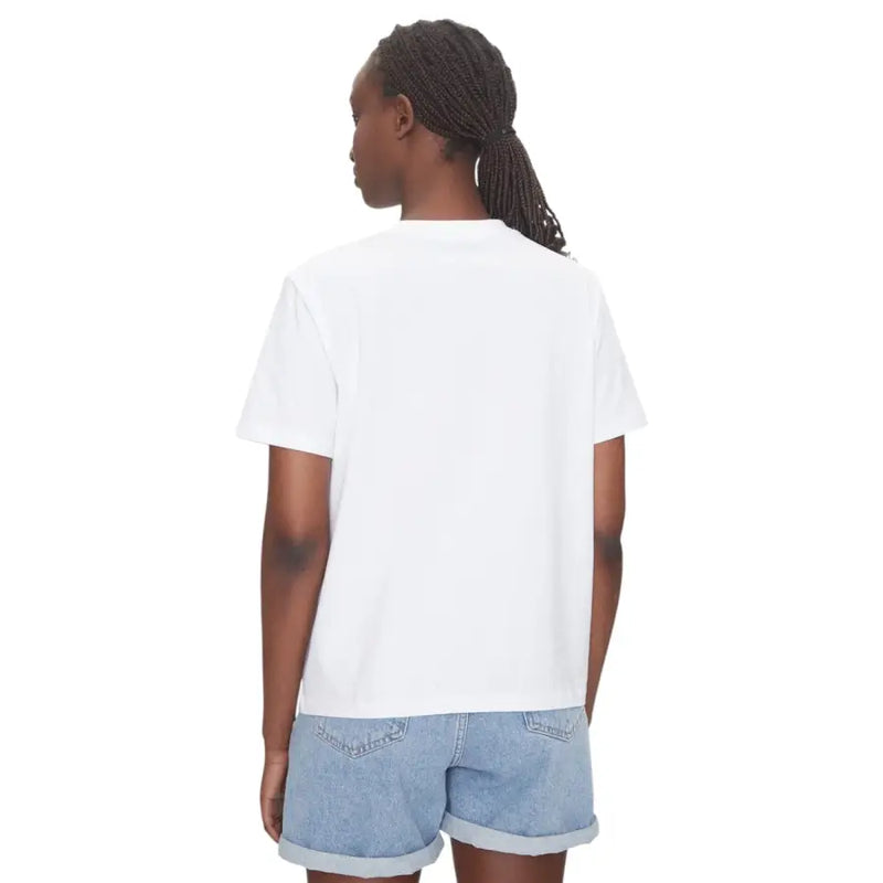 Woman wearing Calvin Klein Jeans white cotton round neck short sleeve T shirt and denim shorts