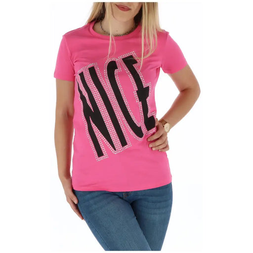 A vibrant pink short-sleeved t shirt with the word nice in bold black letters outlined with sparkling rhinestones