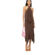 Women wearing a brown halter neck top, matching asymmetric midi skirt, pink shoulder bag, and brown lace-up sandals