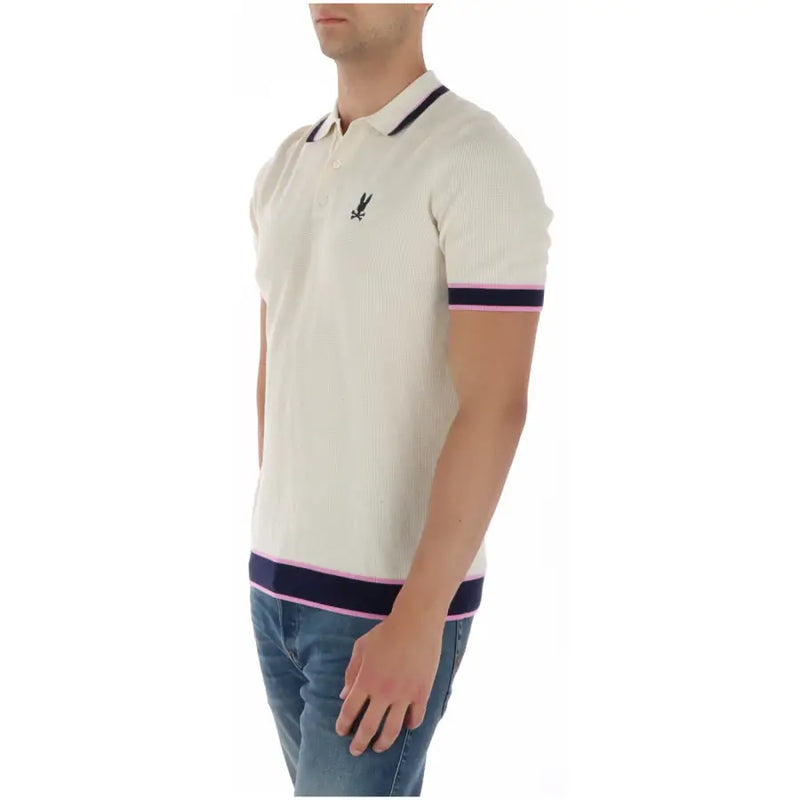 Cremefarbenes, geripptes Baumwoll-Poloshirt für Herren von Psycho Bunny mit marineblauen und rosafarbenen Zierstreifen an Kragen, Ärmeln und Saum.
