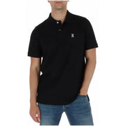 Schwarzes Herren-Polohemd von Psycho Bunny aus Baumwolle mit kurzen Ärmeln und weißem, gesticktem Hasen- und Totenkopflogo auf der linken Brustseite.