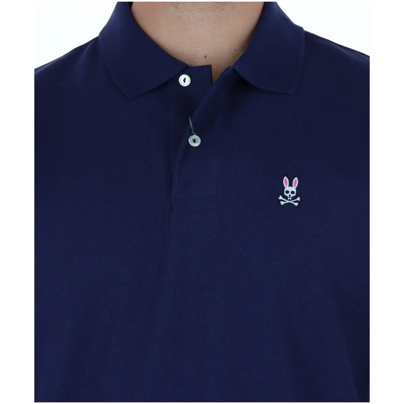 Navy blue cotton Psycho Bunny men polo short sleeve shirt with white embroidered rabbit skull and crossbones logo on chest