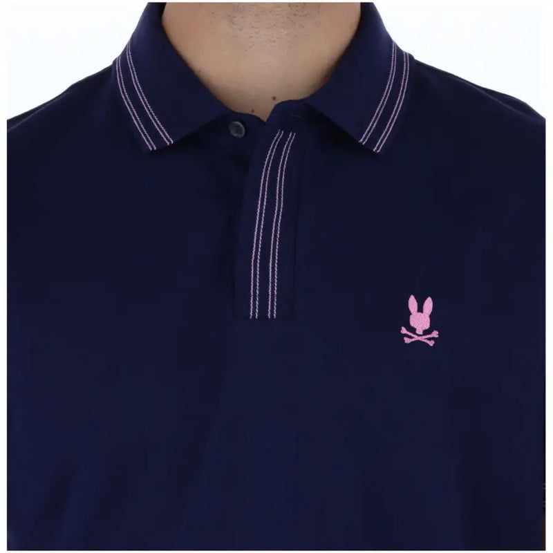Marineblaues Psycho Bunny Herren-Polohemd aus Baumwolle mit kurzen Ärmeln, weißen Doppelnähten und pinkfarbenem, gesticktem Logo