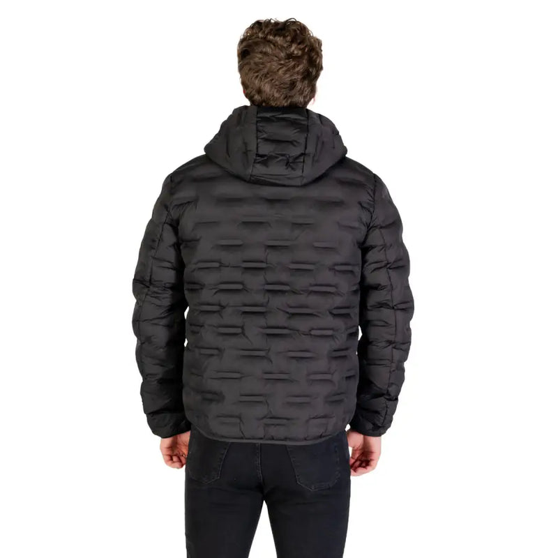 Black quilted down jacket with fur-lined hood and textured pattern.