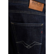 Dark blue denim replay men jeans with brown leather brand patch and white zigzag stitch on back pocket spring summer