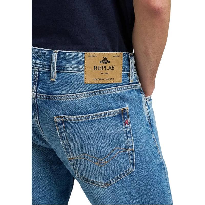 Back side of replay men jeans light blue denim featuring tan leather brand patch and gold stitching on pocket