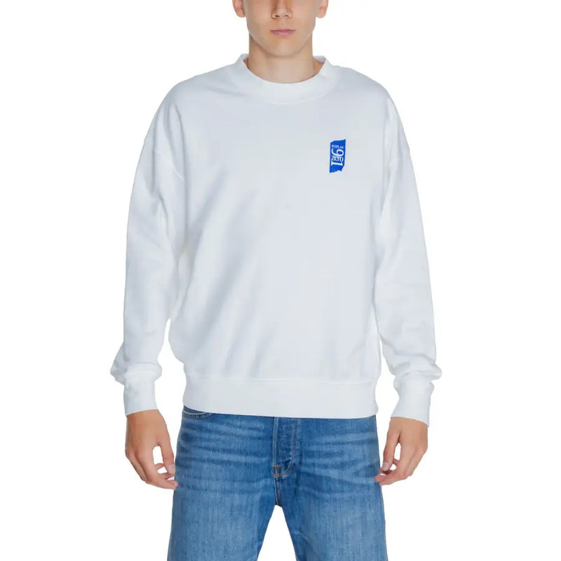Men’s white crewneck sweatshirt with blue graphic on chest paired with blue jeans