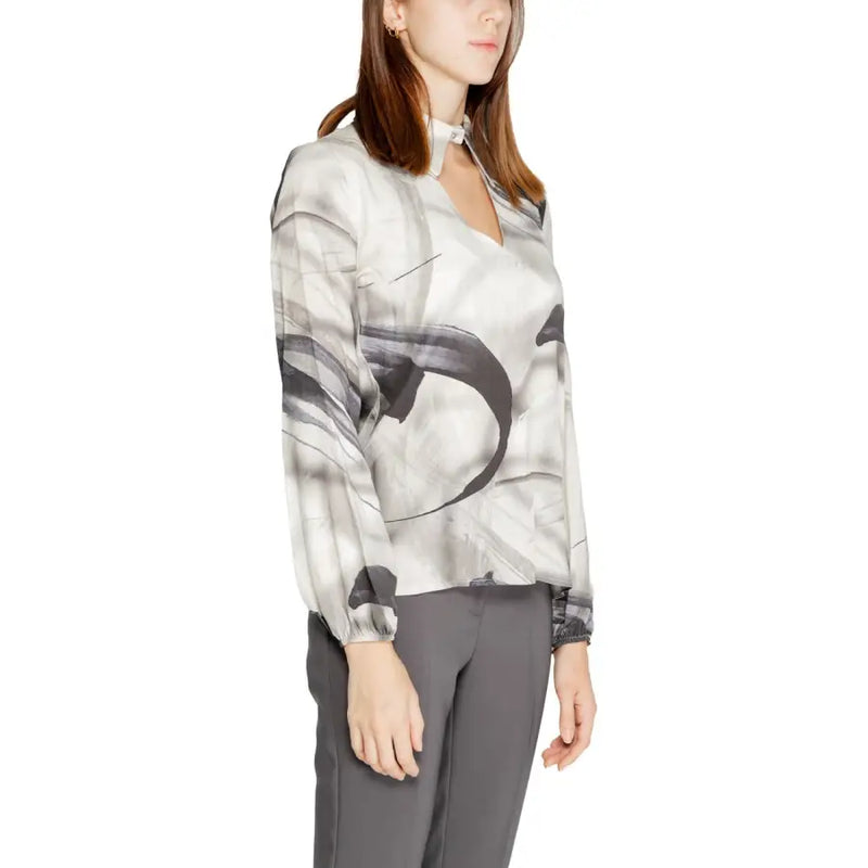 A woman wears a rinascimento grey print long sleeve viscose blouse with abstract black and white brushstroke pattern