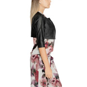 Rinascimento women black polyurethane cropped bolero jacket with three-quarter sleeves worn over floral dress