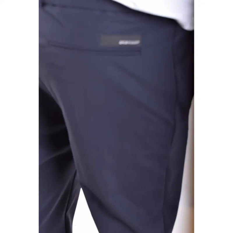 Dark navy blue rrd men trousers with subtle textured fabric and brand label on the back pocket