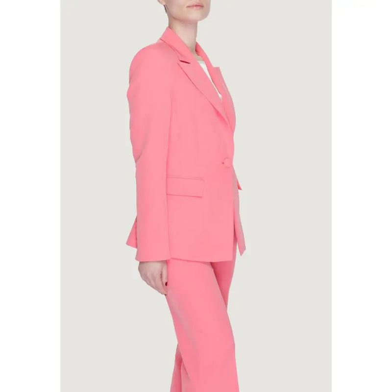 A vibrant coral pink tailored women coral blazer with lapel collar front pockets and matching trousers