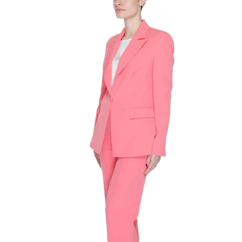 A vibrant coral pink tailored Silence Women blazer with lapel collar, front pockets, and matching modern cut trousers
