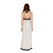 Beige silk sleeveless floor length dress with thin spaghetti straps and black trim for elegant occasions