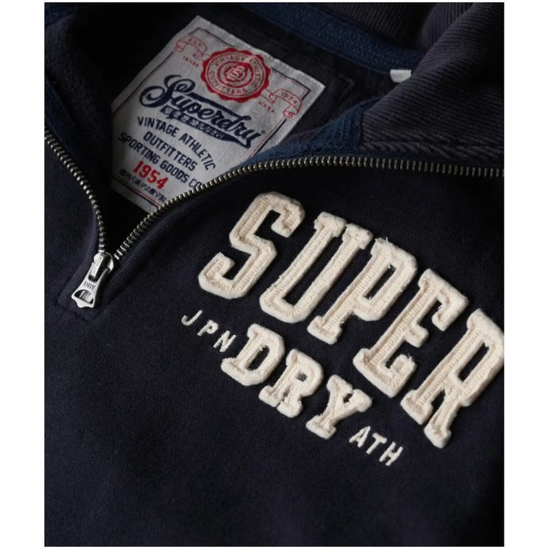Dark navy blue superdry men sweatshirt with cream embroidered lettering and vintage-style brand label in cotton