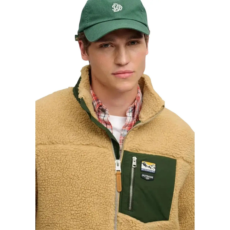 Superdry Gelbes Herren-Fleece-Sweatshirt mit durchgehendem Reißverschluss, beigem Shearling-Futter, dunkelgrüner Tasche und Outdoor Co-Logo-Aufnäher