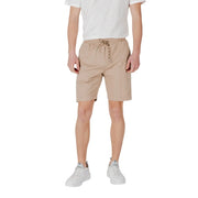 Man wearing Tan Drawstring Shorts and white sneakers in a casual outdoor setting