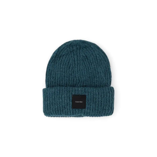Teal ribbed knit beanie with folded cuff and black Calvin Klein logo patch made of soft knit fabric