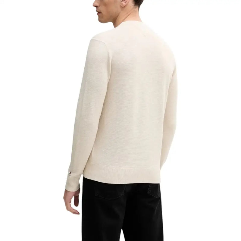 Cream-colored long-sleeved sweater with a ribbed neckline and cuffs, featuring the champion logo on the left chest.
