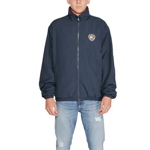 Navy blue Tommy Hilfiger windbreaker jacket with crest emblem and full zipper closure
